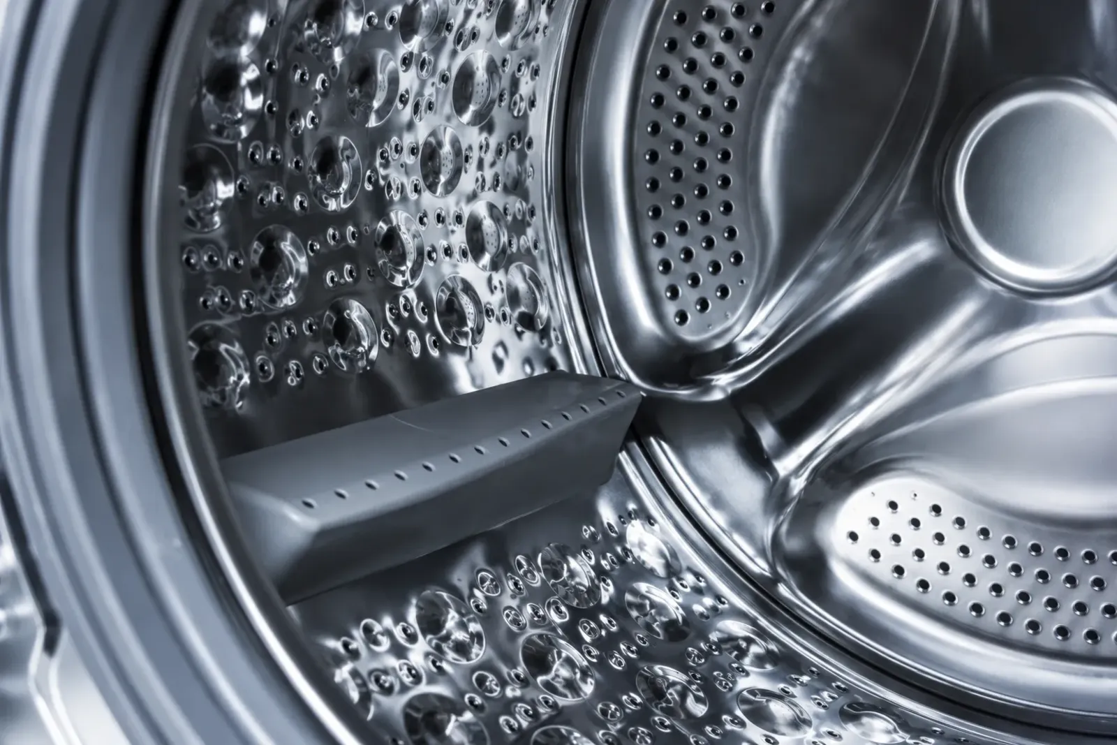 Close-up inside a stainless steel washing machine drum